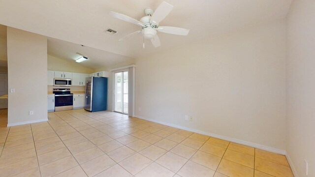 unfurnished living room featuring lofted ceiling, light tile patterned flooring, ceiling fan, and baseboards