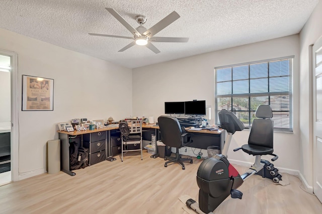 office area with wood finished floors, a ceiling fan, a textured ceiling, and baseboards