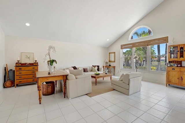 living room with high vaulted ceiling and light tile patterned floors
