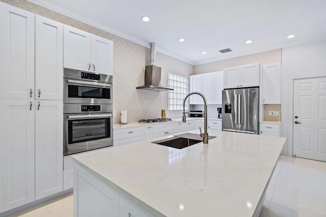 kitchen with stainless steel appliances, crown molding, a sink, a kitchen island with sink, and decorative backsplash