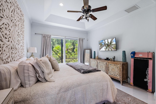 bedroom featuring a tray ceiling, light tile patterned floors, ornamental molding, and ceiling fan