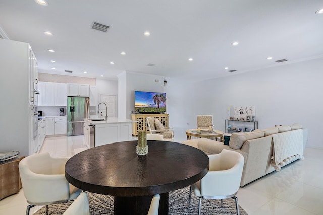 dining room featuring recessed lighting and ornamental molding