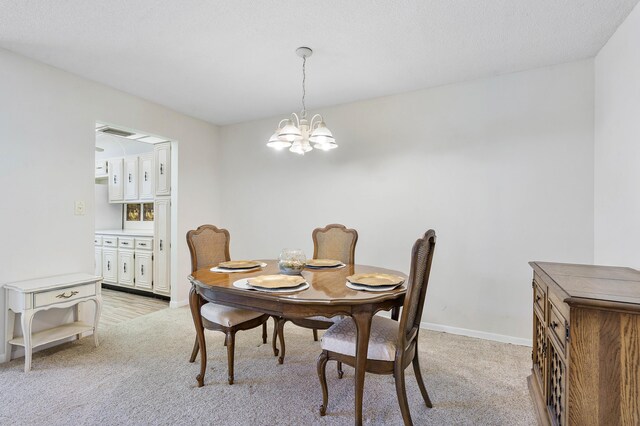 195 High Point Ter E Unit C, Delray Beach, FL 33445 - dining space featuring a chandelier, light colored carpet, and baseboards