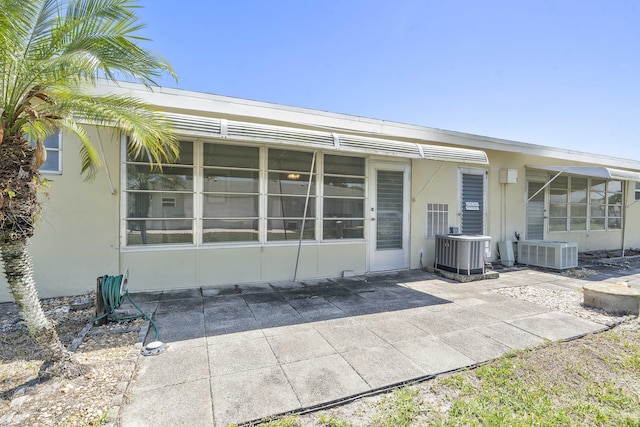 195 High Point Ter E Unit C, Delray Beach, FL 33445 - rear view of property with central AC unit, a patio area, and stucco siding