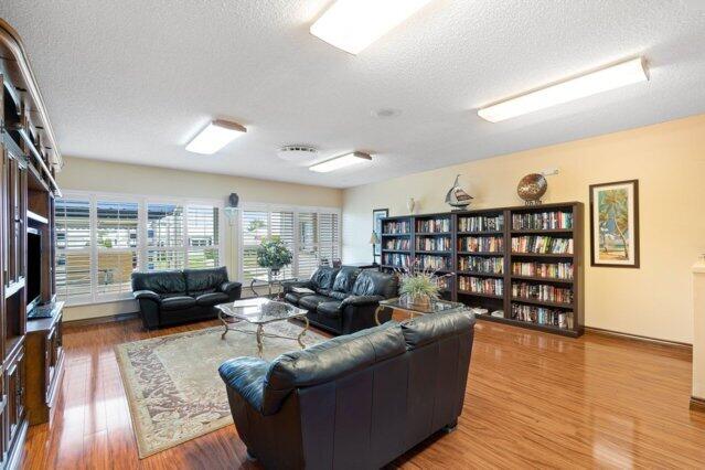living room featuring a textured ceiling and wood finished floors