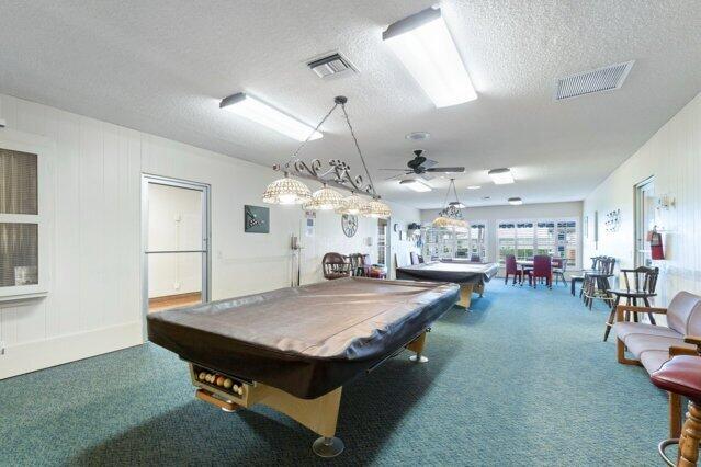 recreation room featuring carpet, a textured ceiling, a ceiling fan, and billiards table