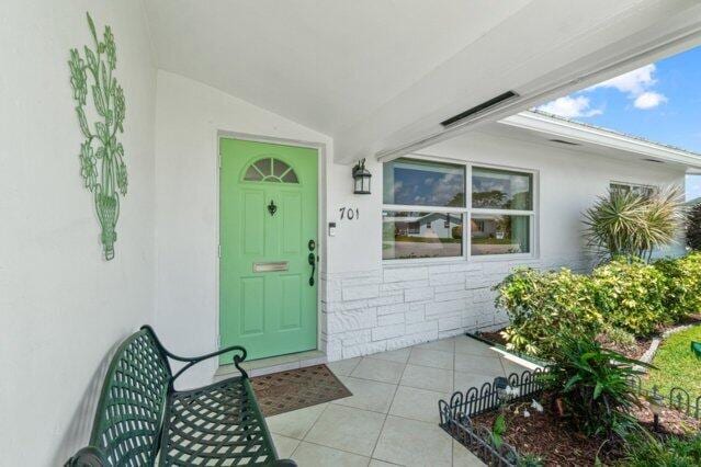 entrance to property featuring stucco siding