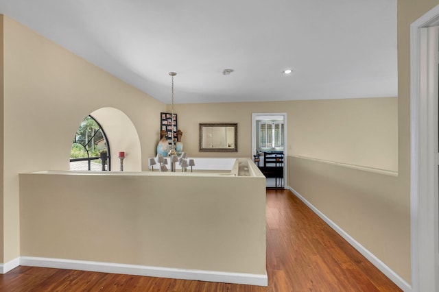 bar featuring healthy amount of natural light, wood finished floors, baseboards, decorative light fixtures, and recessed lighting