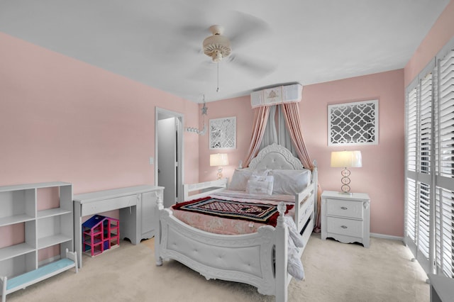 carpeted bedroom featuring multiple windows, a ceiling fan, and baseboards