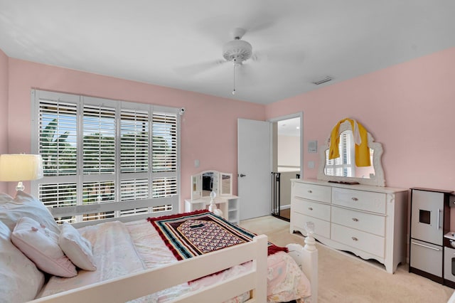 bedroom featuring light carpet and a ceiling fan