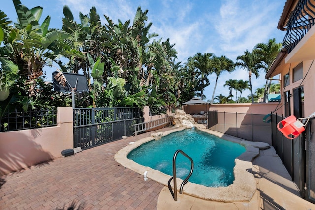 view of swimming pool with a fenced backyard and a patio area