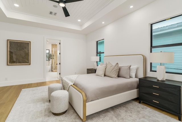 1105 NE 2nd Ave, Delray Beach, FL 33444 - bedroom with a raised ceiling, wood finished floors, recessed lighting, multiple windows, and ensuite bath