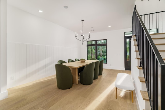 1105 NE 2nd Ave, Delray Beach, FL 33444 - dining room featuring light wood-style flooring, a chandelier, stairs, a wainscoted wall, and baseboards