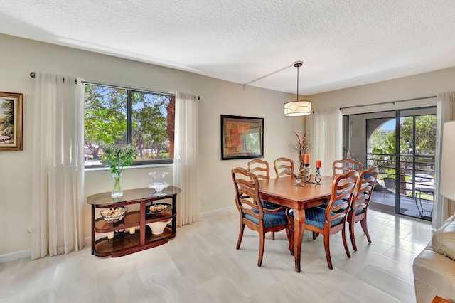 6328 Longboat Ln Unit 302, Boca Raton, FL 33433 - dining area with a textured ceiling and baseboards