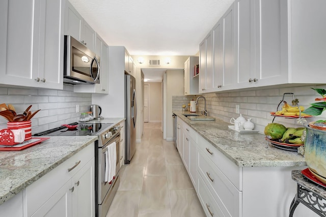 6328 Longboat Ln Unit 302, Boca Raton, FL 33433 - kitchen with stainless steel appliances, a sink, tasteful backsplash, and white cabinets
