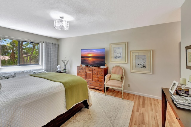 6328 Longboat Ln Unit 302, Boca Raton, FL 33433 - bedroom with light wood-style floors, baseboards, and a textured ceiling