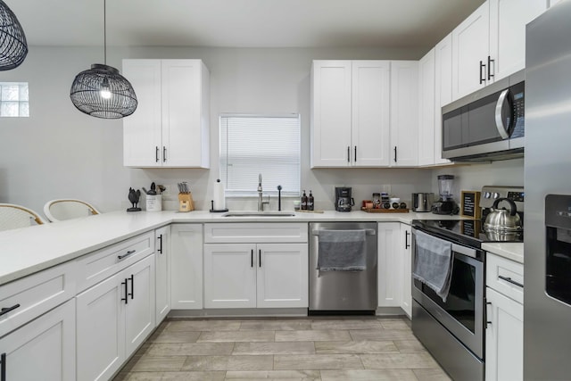 18 S D St, Lake Worth Beach, FL 33460 - kitchen featuring appliances with stainless steel finishes, a sink, light countertops, and white cabinetry