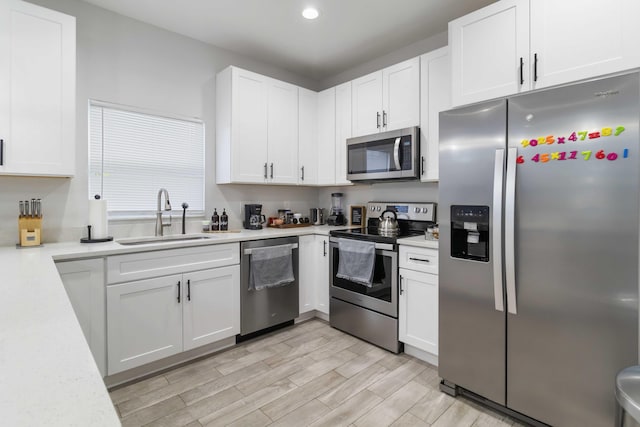 18 S D St, Lake Worth Beach, FL 33460 - kitchen featuring appliances with stainless steel finishes, a sink, light countertops, white cabinets, and recessed lighting