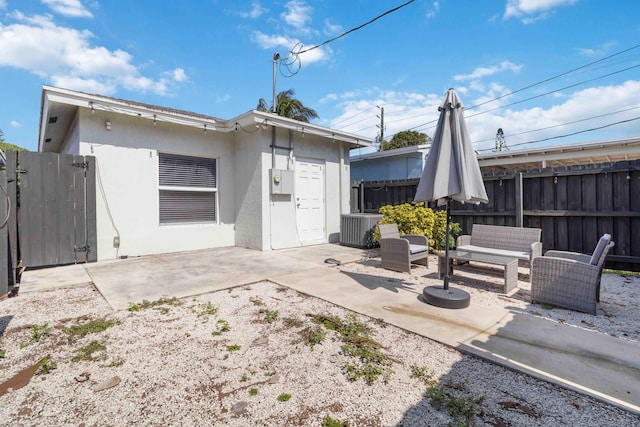 18 S D St, Lake Worth Beach, FL 33460 - rear view of property featuring central AC, fence, a patio area, and stucco siding