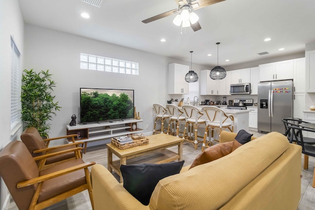 18 S D St, Lake Worth Beach, FL 33460 - living room with light wood finished floors, a ceiling fan, recessed lighting, and baseboards