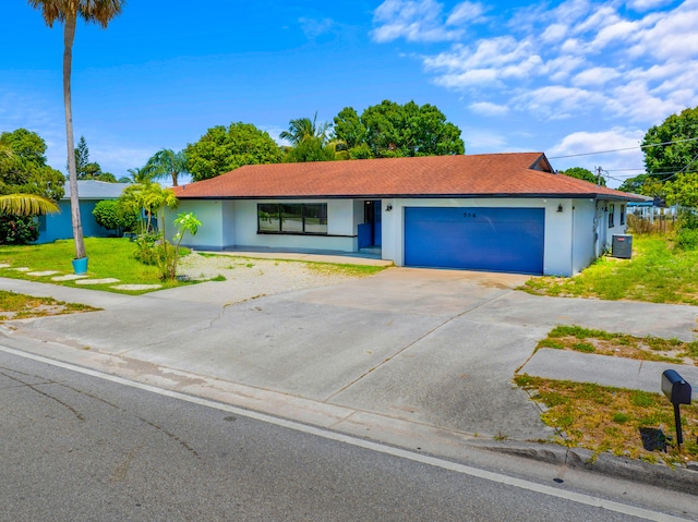 356 SE Prima Vista Blvd, Port Saint Lucie, FL 34983 - ranch-style home featuring stucco siding, an attached garage, central air condition unit, concrete driveway, and a front yard