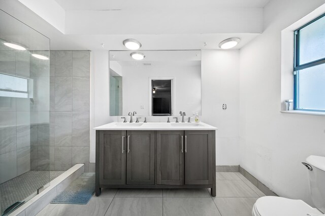 356 SE Prima Vista Blvd, Port Saint Lucie, FL 34983 - bathroom with double vanity, toilet, walk in shower, and baseboards