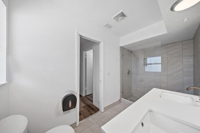 356 SE Prima Vista Blvd, Port Saint Lucie, FL 34983 - full bathroom with toilet, a stall shower, baseboards, a sink, and tile patterned flooring
