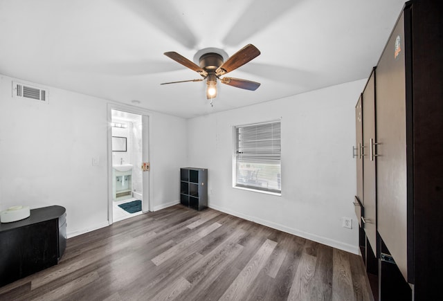 356 SE Prima Vista Blvd, Port Saint Lucie, FL 34983 - unfurnished living room with wood finished floors, a ceiling fan, and baseboards