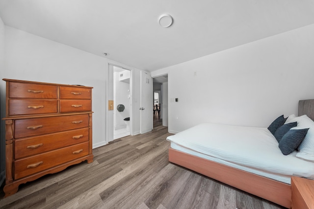 356 SE Prima Vista Blvd, Port Saint Lucie, FL 34983 - bedroom with wood finished floors, baseboards, and ensuite bath