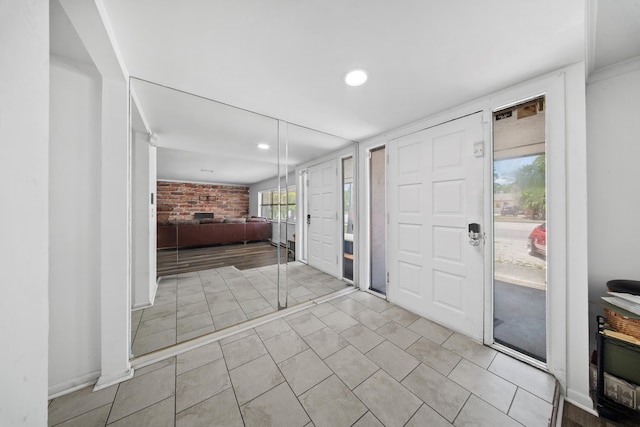 356 SE Prima Vista Blvd, Port Saint Lucie, FL 34983 - entrance foyer with brick wall and recessed lighting