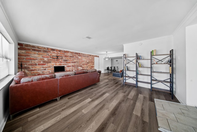 356 SE Prima Vista Blvd, Port Saint Lucie, FL 34983 - living room featuring wood finished floors, brick wall, and ornamental molding