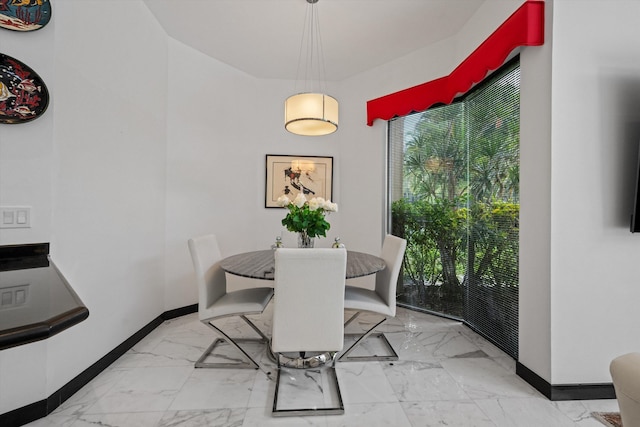 dining space with marble finish flooring and baseboards