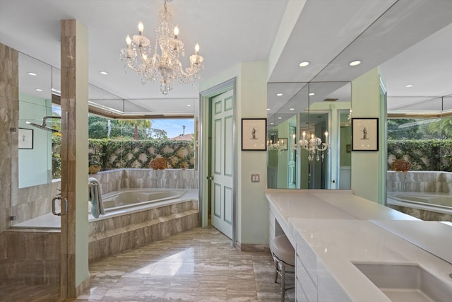 full bath featuring a chandelier, marble tiled floors, a garden tub, recessed lighting, and double vanity