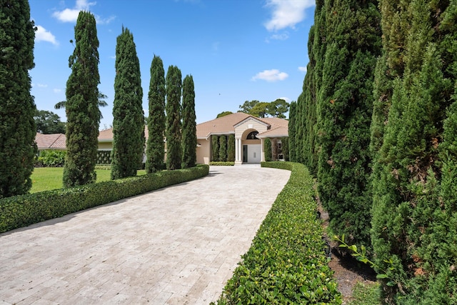 mediterranean / spanish house featuring decorative driveway and stucco siding