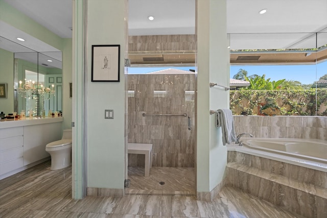 bathroom featuring a garden tub, a stall shower, toilet, recessed lighting, and vanity