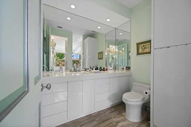 full bathroom with toilet, recessed lighting, and vanity