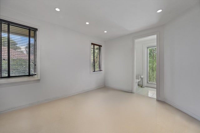 empty room featuring recessed lighting and baseboards