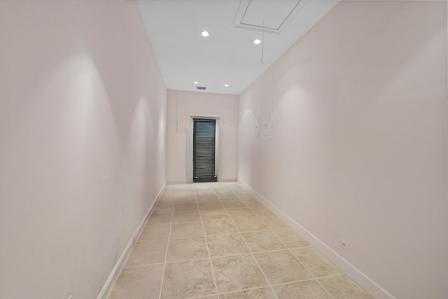 corridor with attic access, recessed lighting, light tile patterned floors, and baseboards