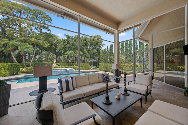 sunroom / solarium with an outdoor living space and view of scattered trees