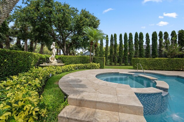view of swimming pool with a pool with connected hot tub