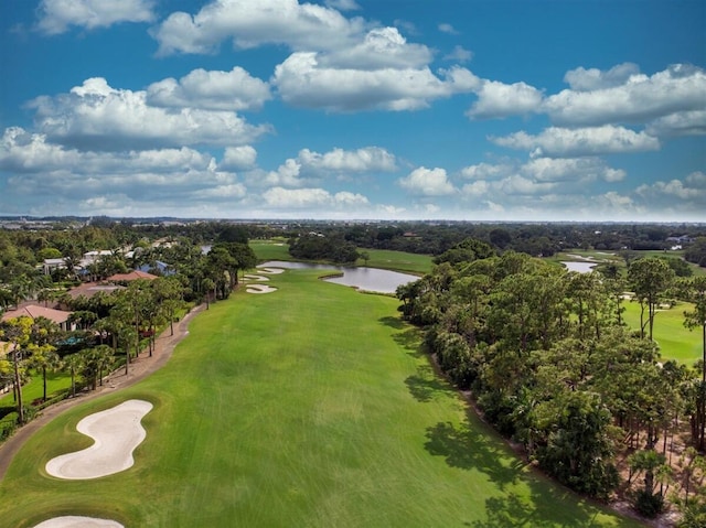 bird's eye view of a large body of water, a golf course, and a tree filled landscape