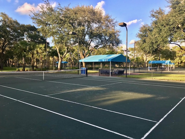 view of tennis court featuring fence