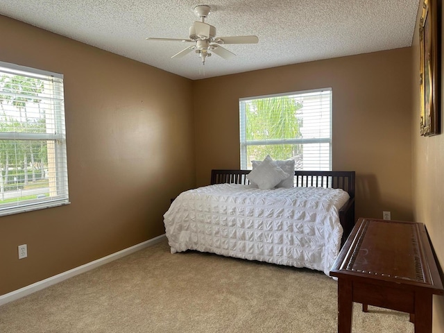 1915 Capeside Cir, Wellington, FL 33414 - carpeted bedroom featuring a textured ceiling, a ceiling fan, and baseboards
