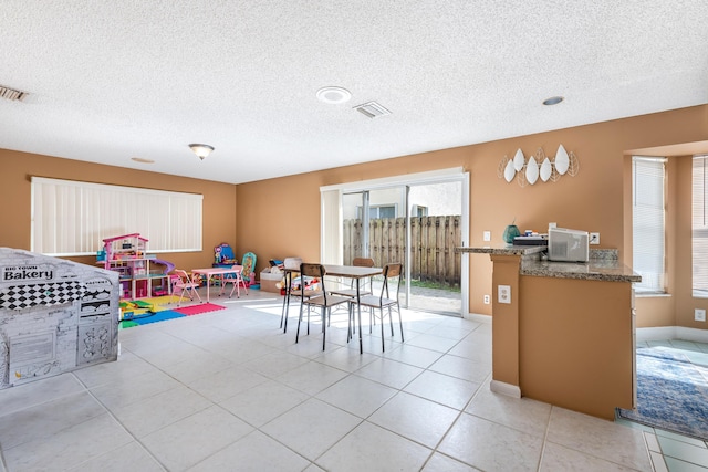 1915 Capeside Cir, Wellington, FL 33414 - dining space featuring a textured ceiling and light tile patterned floors