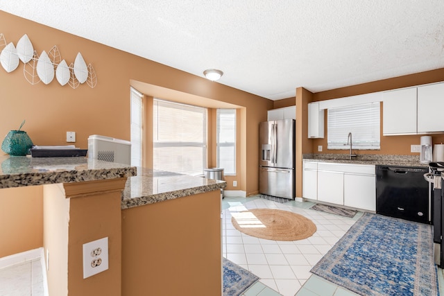 1915 Capeside Cir, Wellington, FL 33414 - kitchen featuring stainless steel refrigerator with ice dispenser, black dishwasher, a textured ceiling, white cabinets, and a sink