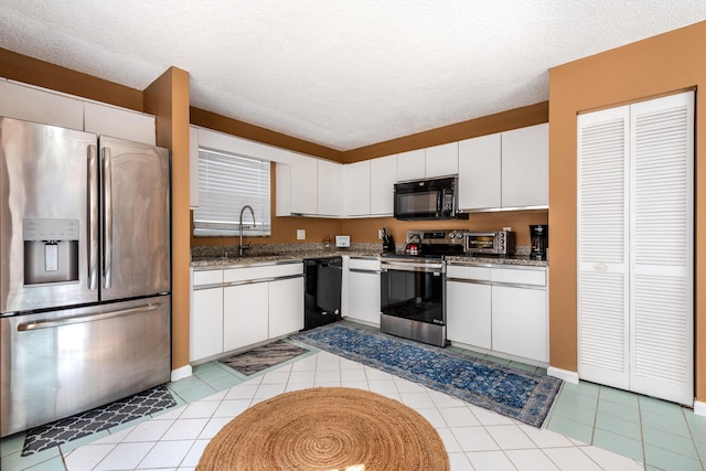 1915 Capeside Cir, Wellington, FL 33414 - kitchen with black appliances, a sink, white cabinets, and a textured ceiling