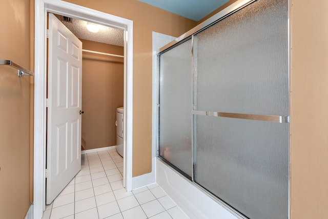 1915 Capeside Cir, Wellington, FL 33414 - bathroom featuring toilet, tile patterned floors, shower / bath combination with glass door, baseboards, and a textured ceiling