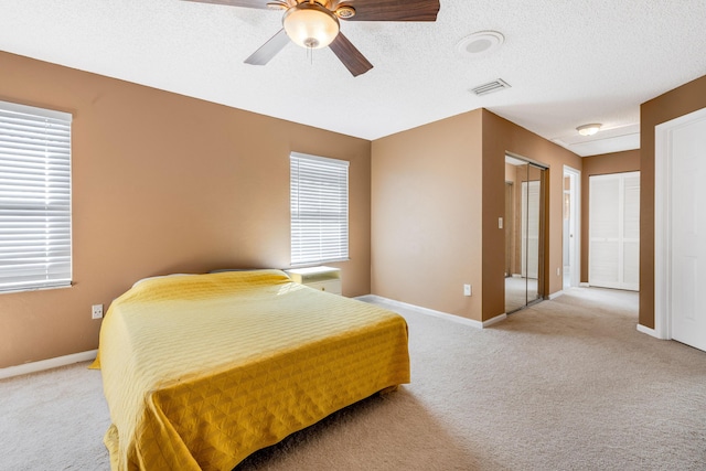 1915 Capeside Cir, Wellington, FL 33414 - bedroom featuring light carpet, baseboards, ceiling fan, and a textured ceiling