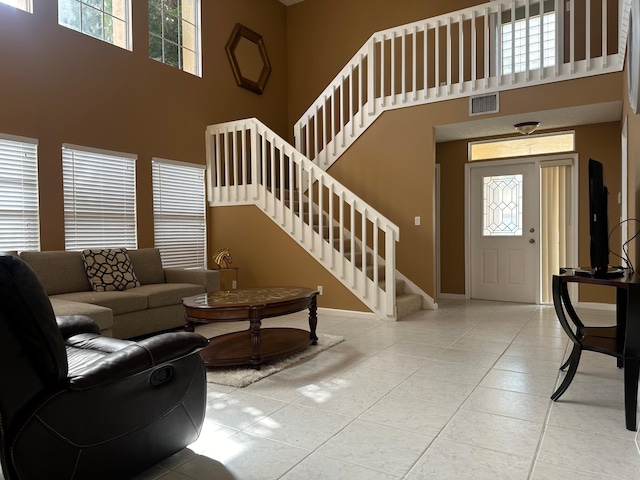 1915 Capeside Cir, Wellington, FL 33414 - tiled living room featuring a high ceiling, stairway, plenty of natural light, and baseboards