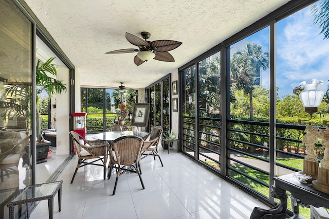 sunroom / solarium featuring a ceiling fan and outdoor dining space